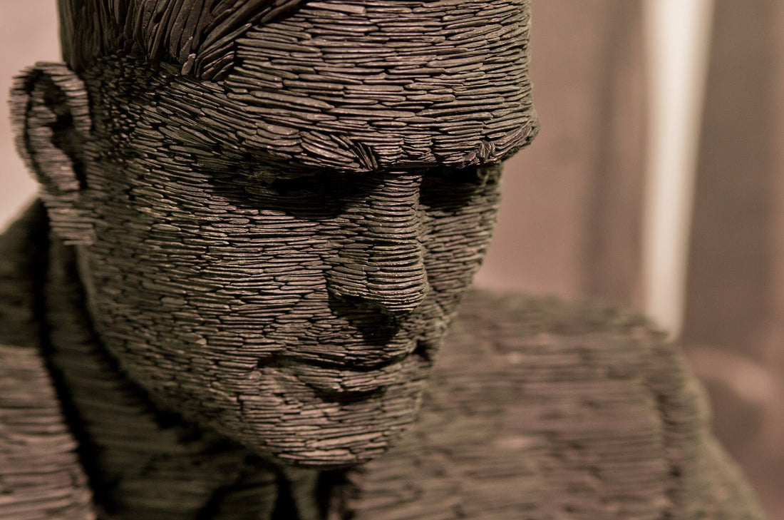 Detail of the face of the slate statue of Alan Turing at Bletchley Park