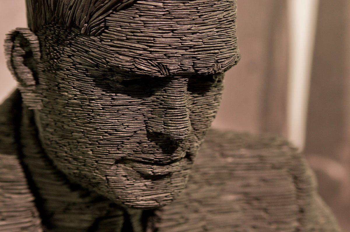 Detail of the face of the slate statue of Alan Turing at Bletchley Park