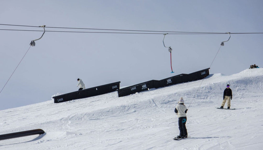 Snowboarders in the LAAX snowpark above Flims, in the Swiss Alps