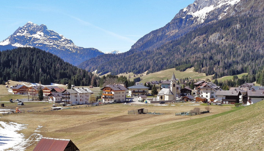 Cima Sappada with the church of Sant'Osvaldo and the snow-covered Dolomites in the background