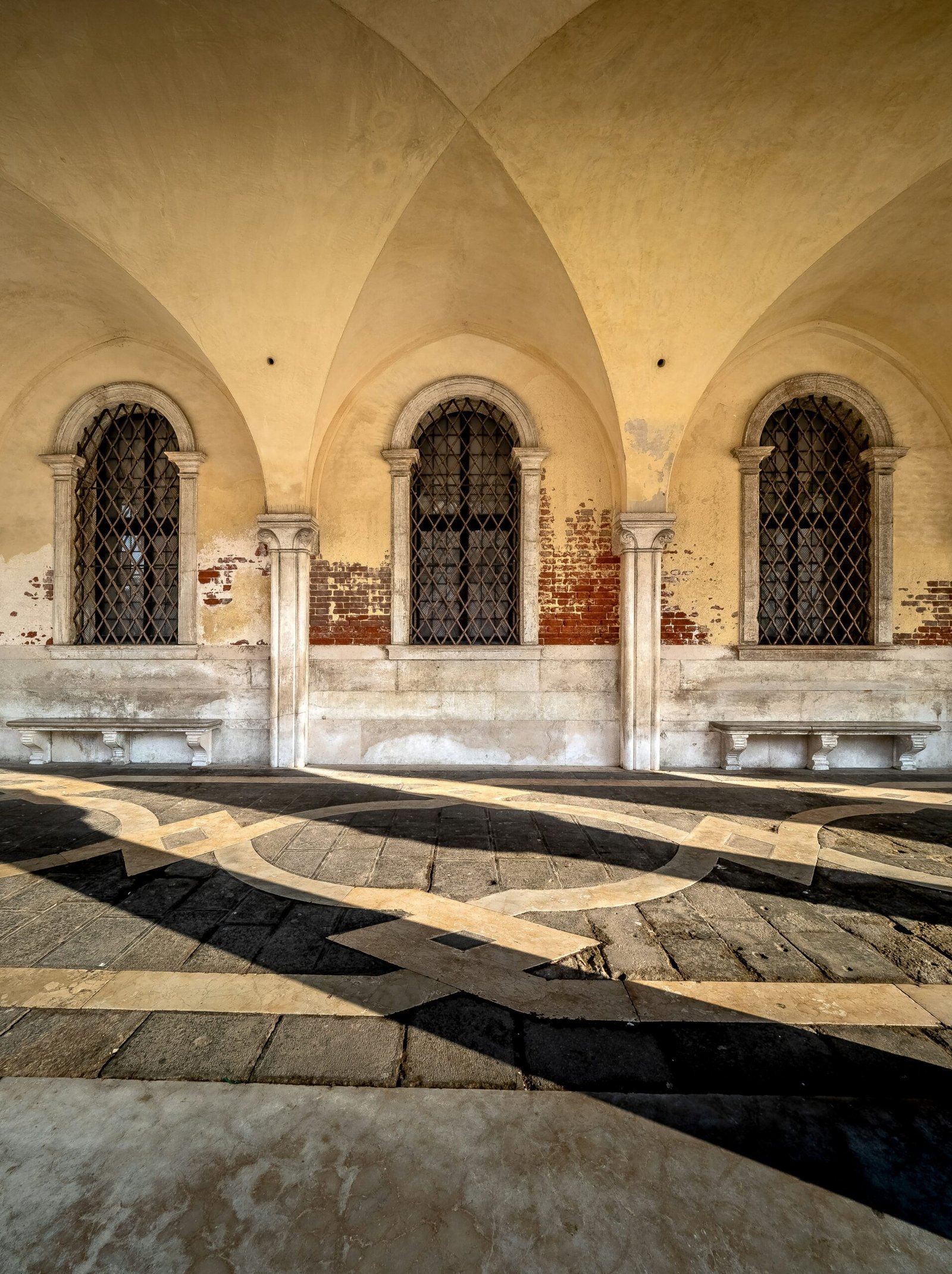 a large building with arched windows and a tiled floor