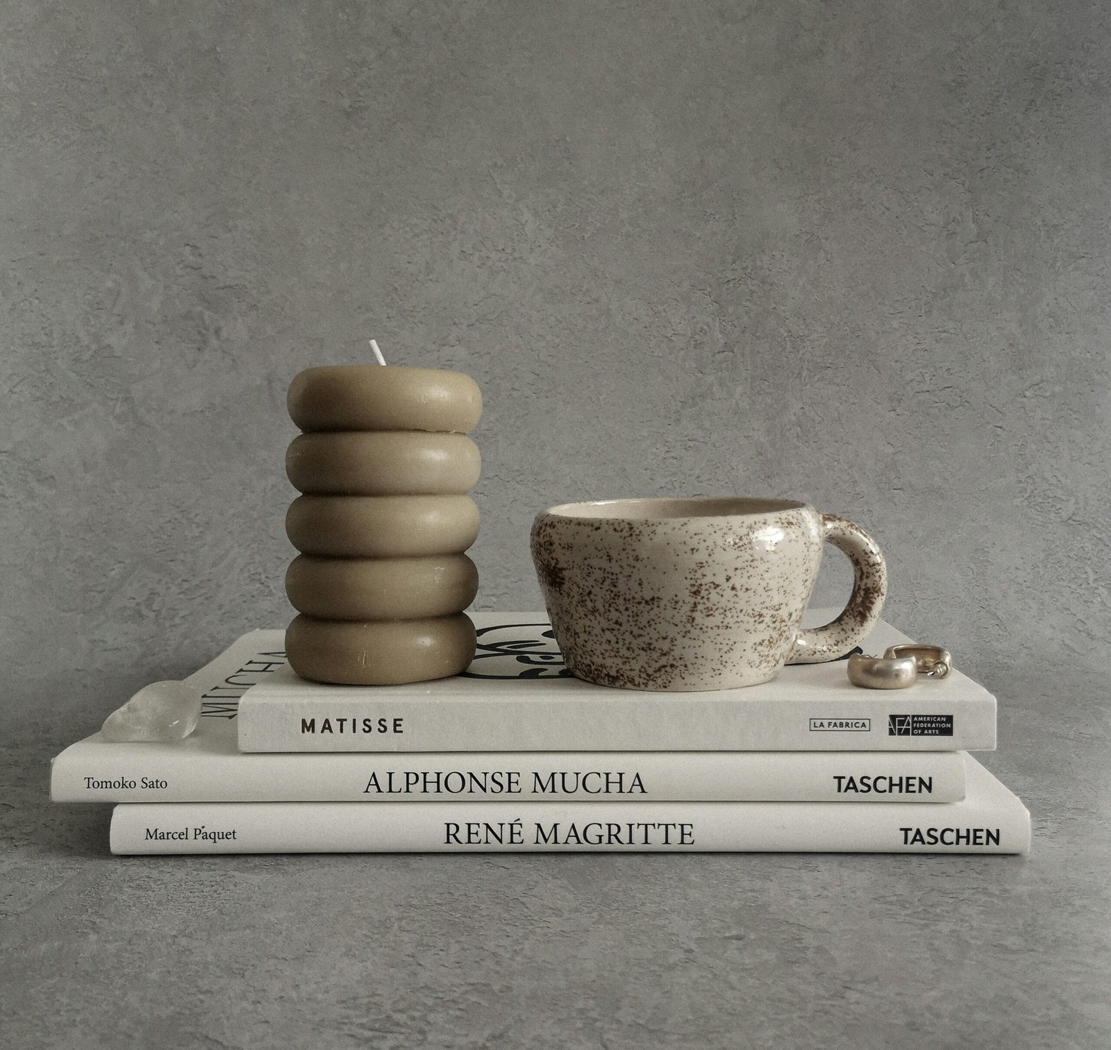 a stack of books and a cup