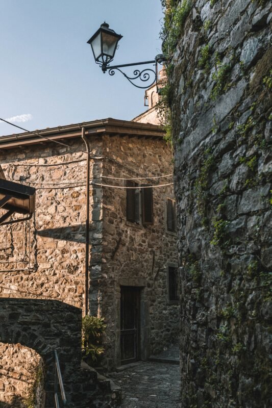 a stone building with a lamp on top of it