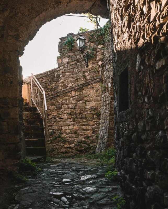 a stone street with a stone staircase going up it