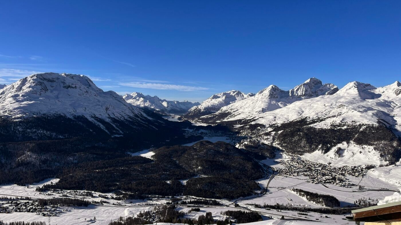 a view of a snowy mountain range with mountains in the background a view of a snowy mountain range with mountains in the background