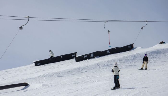 Snowboarders in the LAAX snowpark above Flims, in the Swiss Alps