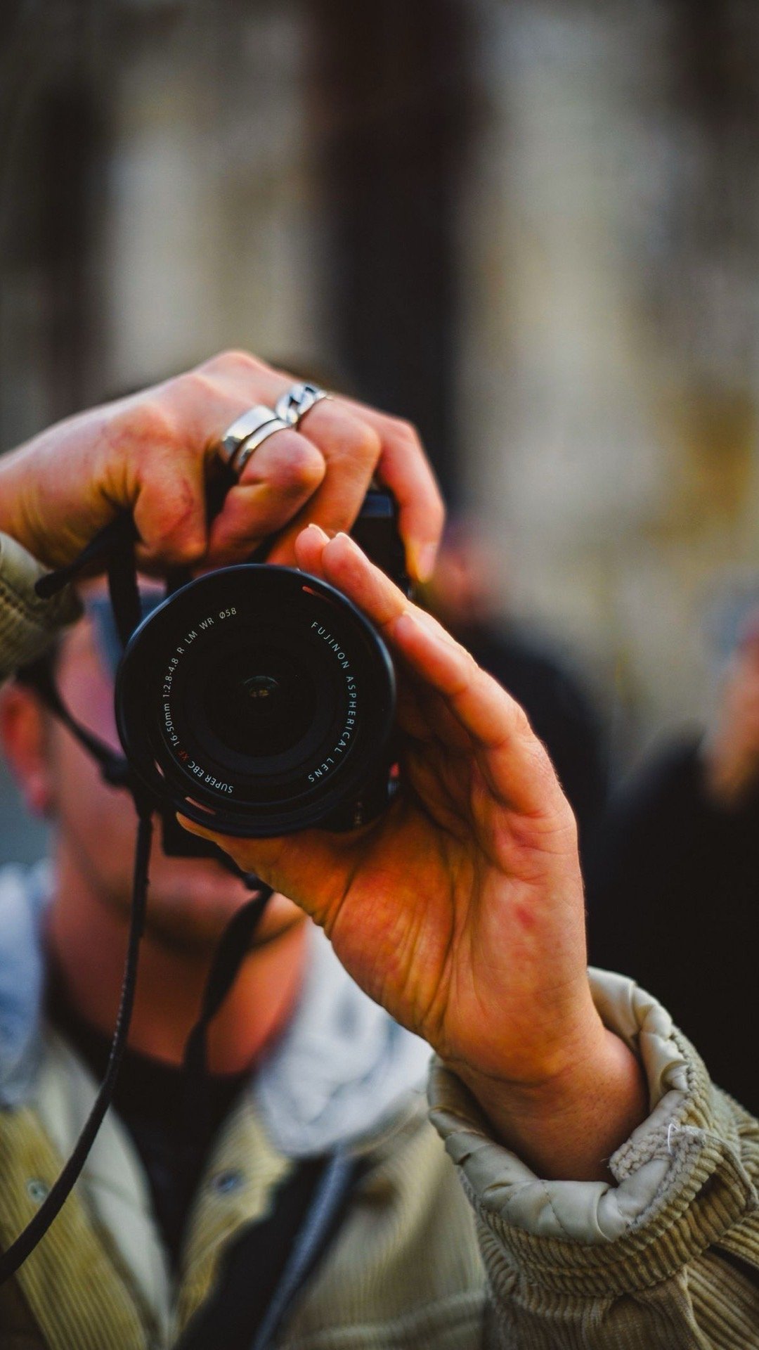 Hands holding a camera, capturing a detail in warm light